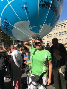 Monika at fridays for future with walking balloon planet earth first